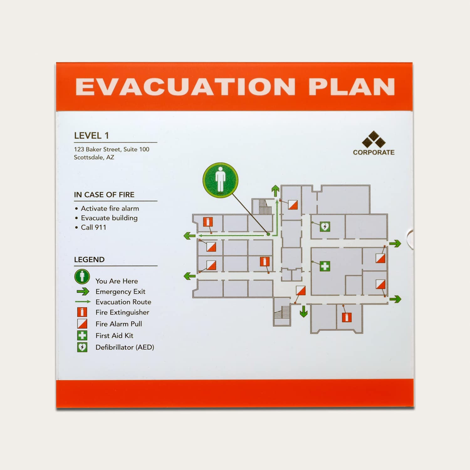 Acrylic slide-in frame with red header evacuation plan showing level 1 floor layout, corporate branding, and fire safety icons
