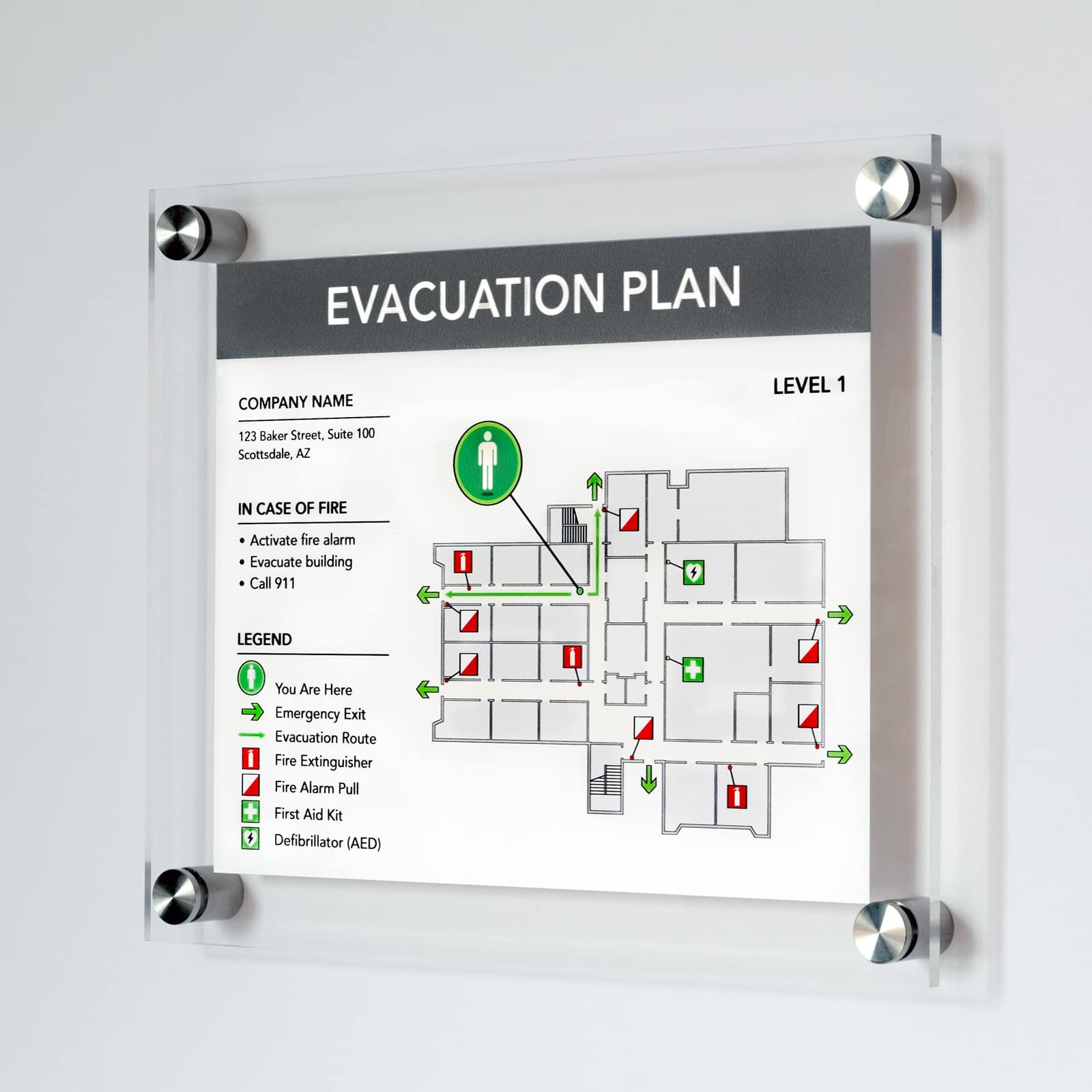 Premium acrylic evacuation plan with brushed steel standoff mounts showing level 1 floor layout, fire safety icons, and emergency procedures