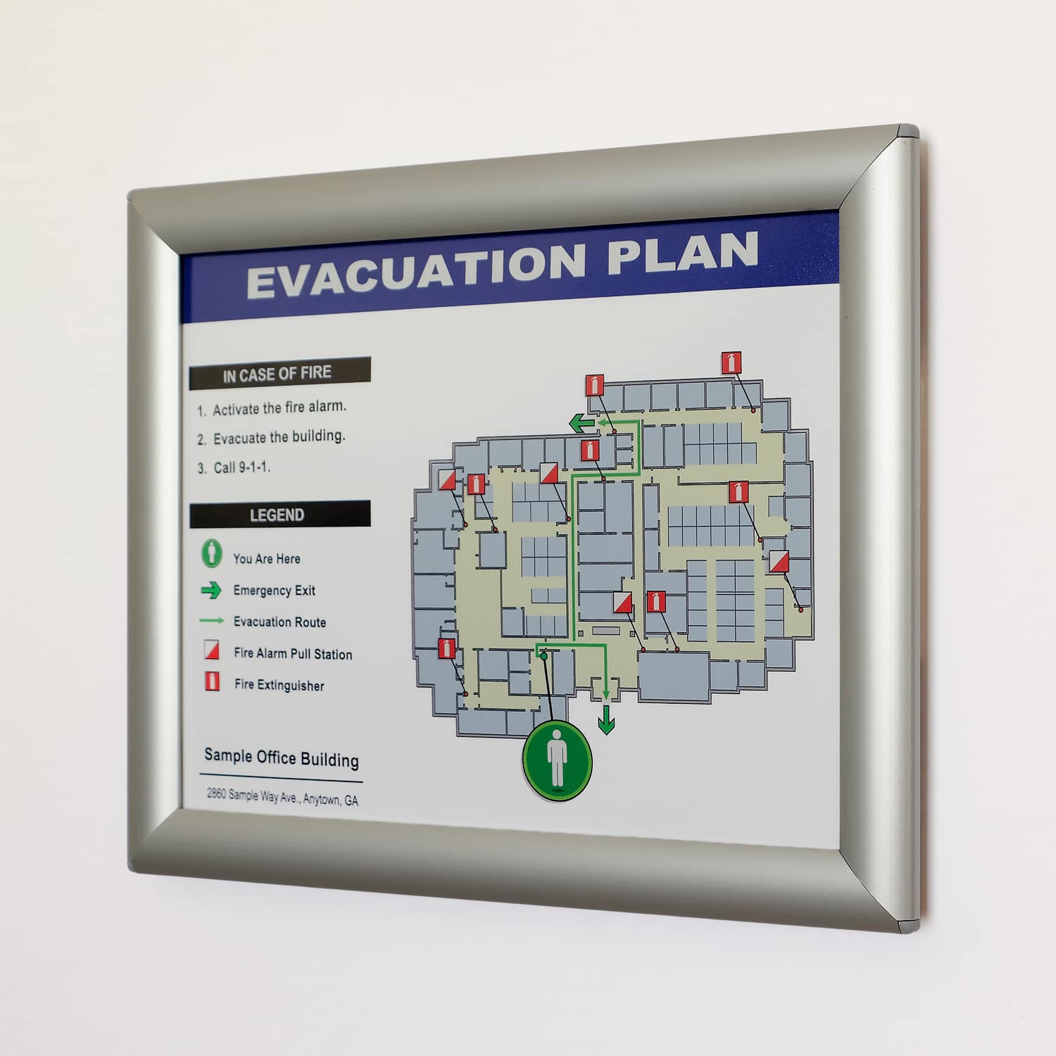 Silver aluminum quick-change snap frame holding evacuation plan with blue header, office building floor layout, and emergency procedures