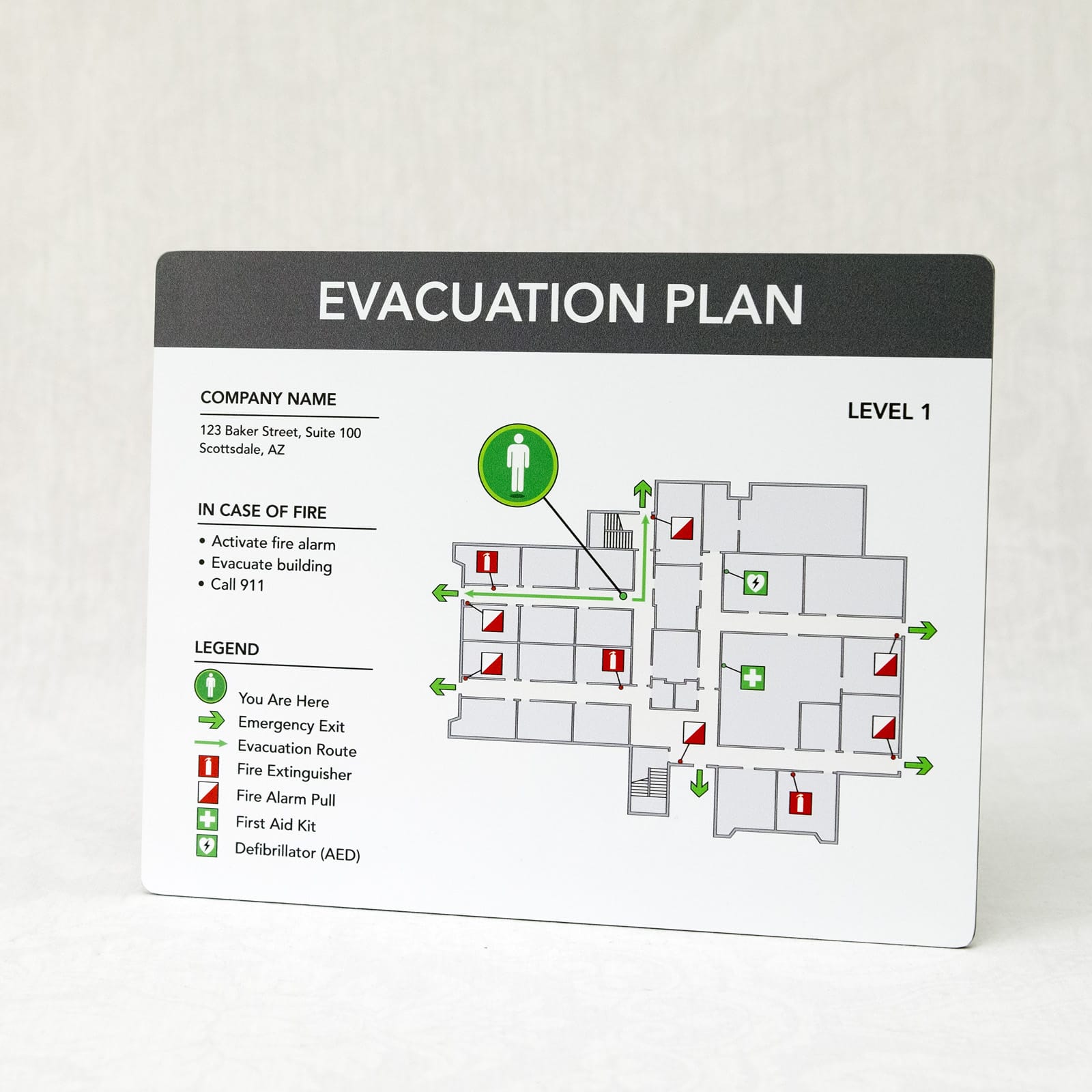 White aluminum evacuation plan full view showing level 1 floor layout with fire safety icons, AED locations, and emergency procedures